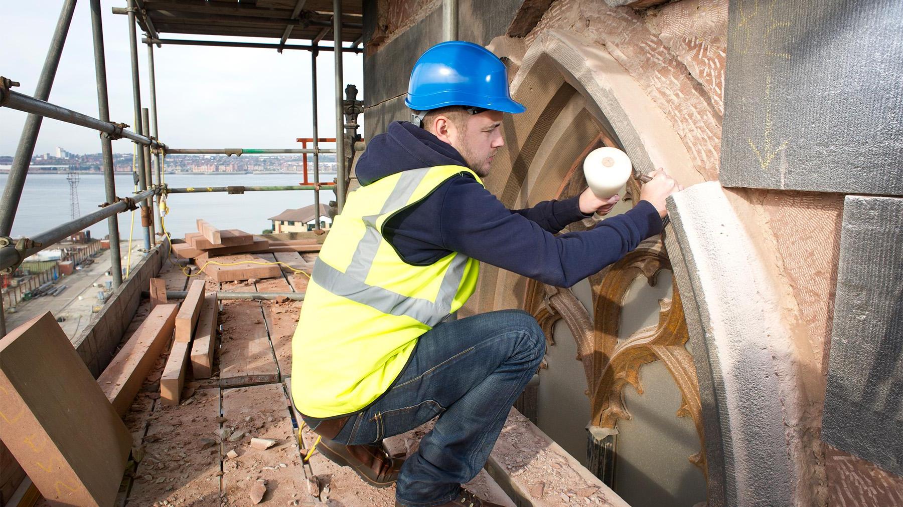 Mann working on an old church