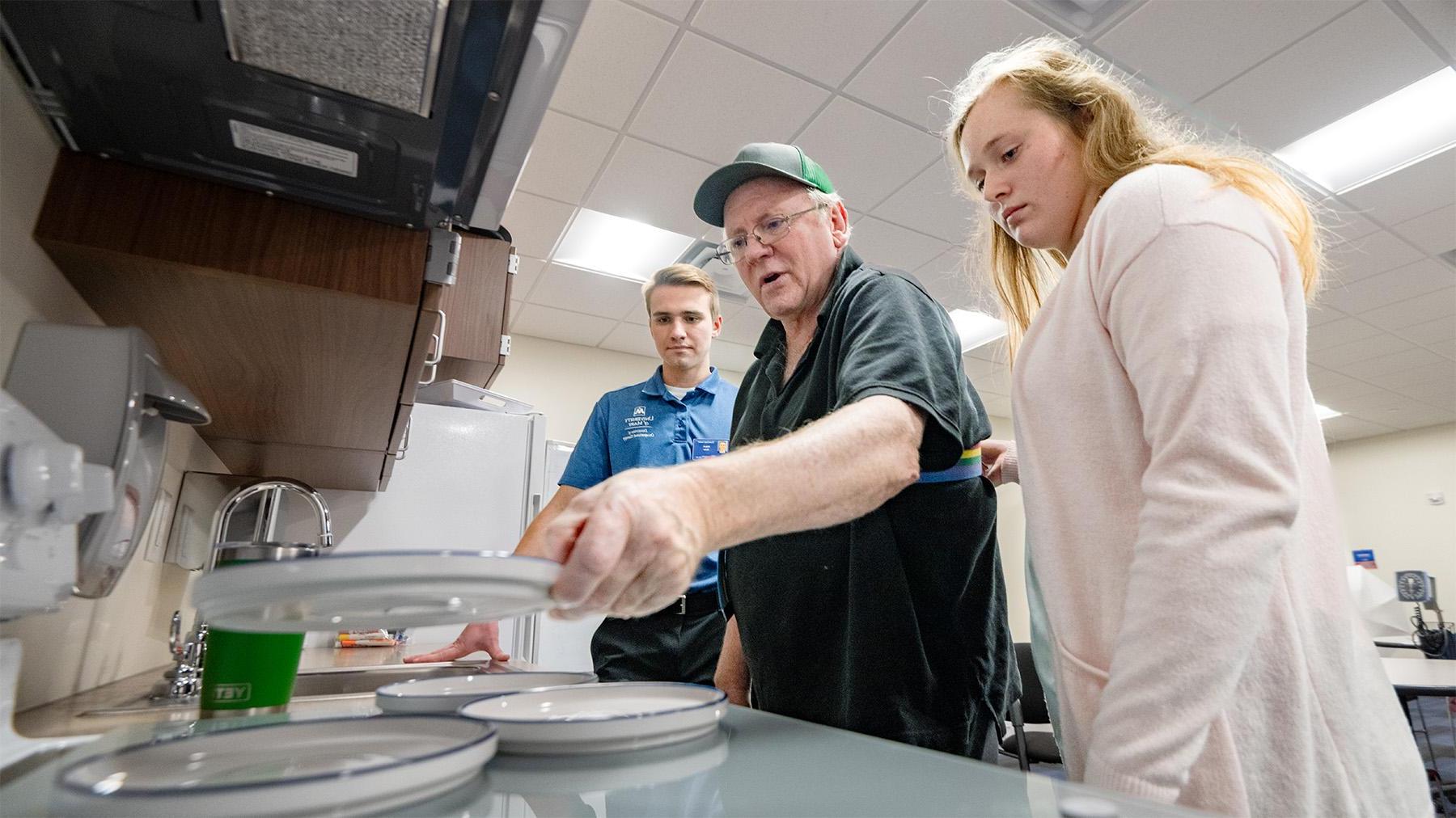 Students working with a elderly man